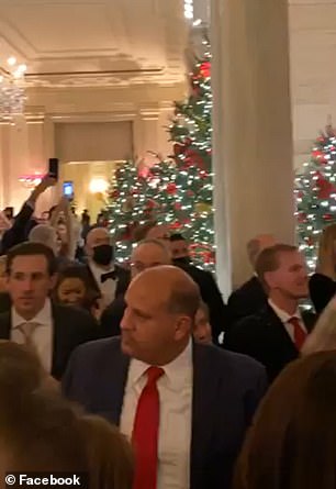 Footage of the event was shared by a guest on social media and showed dozens of people - many who were not wearing masks - crammed into the Cross Hall of the White House state floor