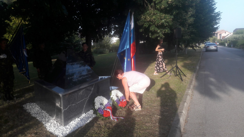 				Marija, sestra Alojza Gaubeta polaga venec na pomnik svojemu bratu			